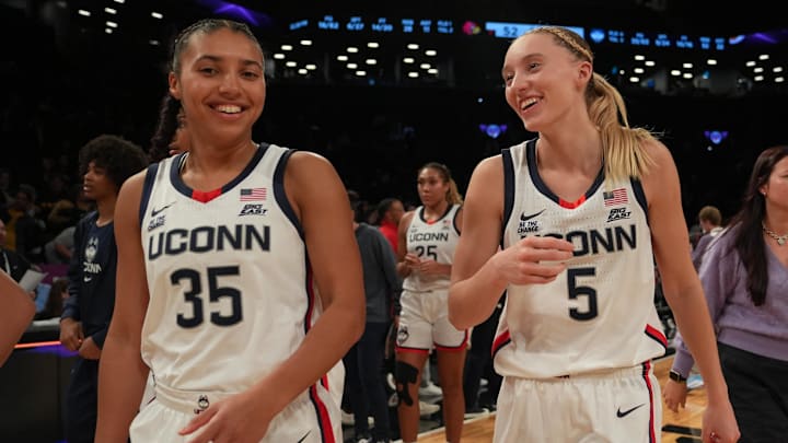 Dec 7, 2024; Brooklyn, New York, USA; Connecticut Huskies guard Azzi Fudd (35) and Connecticut Huskies guard Paige Bueckers (5) celebrate after the game against the Louisville Cardinals at Barclays Center. Mandatory Credit: Lucas Boland-Imagn Images