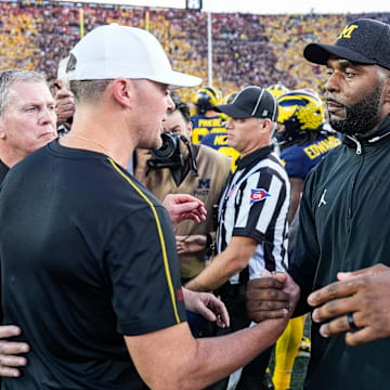 Michigan head coach Sherrone Moore shakes hands with USC head coach Lincoln Riley after 27-24 win at Michigan Stadium in Ann Arbor on Saturday, Sept. 21, 2024.