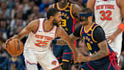 Mar 15, 2025; San Francisco, California, USA; New York Knicks forward Mikal Bridges (25) controls the basketball against Golden State Warriors guard Gary Payton II (0) during the fourth quarter at Chase Center. Mandatory Credit: Neville E. Guard-Imagn Images