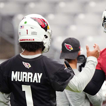 Arizona Cardinals quarterback Kyler Murray (1) high-fives teammate Marvin Harrison (18) during the team's training camp session at State Farm Stadium in Glendale on July 24, 2024.