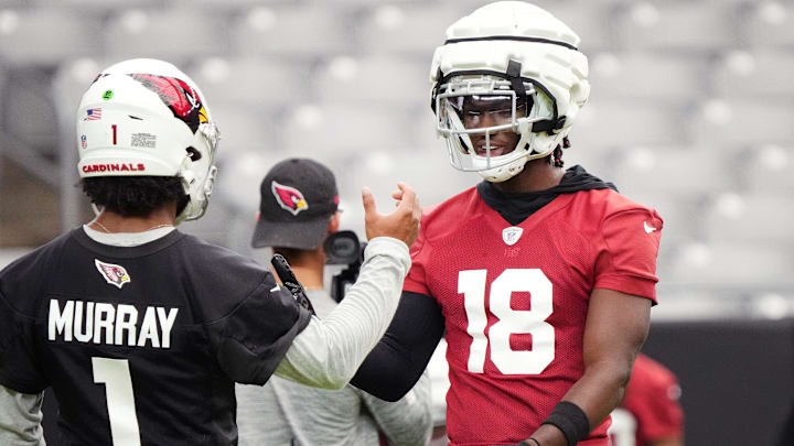 Arizona Cardinals quarterback Kyler Murray (1) high-fives teammate Marvin Harrison (18) during the team's training camp session at State Farm Stadium in Glendale on July 24, 2024.