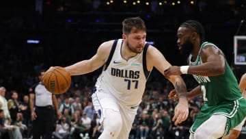 Jun 17, 2024; Boston, Massachusetts, USA; Dallas Mavericks guard Luka Doncic (77) dribbles the ball against Boston Celtics guard Jaylen Brown (7) during the second quarter in game five of the 2024 NBA Finals at TD Garden. Mandatory Credit: Peter Casey-USA TODAY Sports