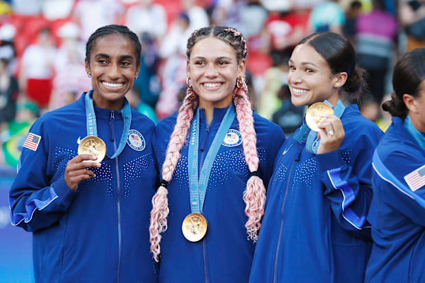 Girma and the Triple Espresso attacking trio celebrating a gold medal in Paris.