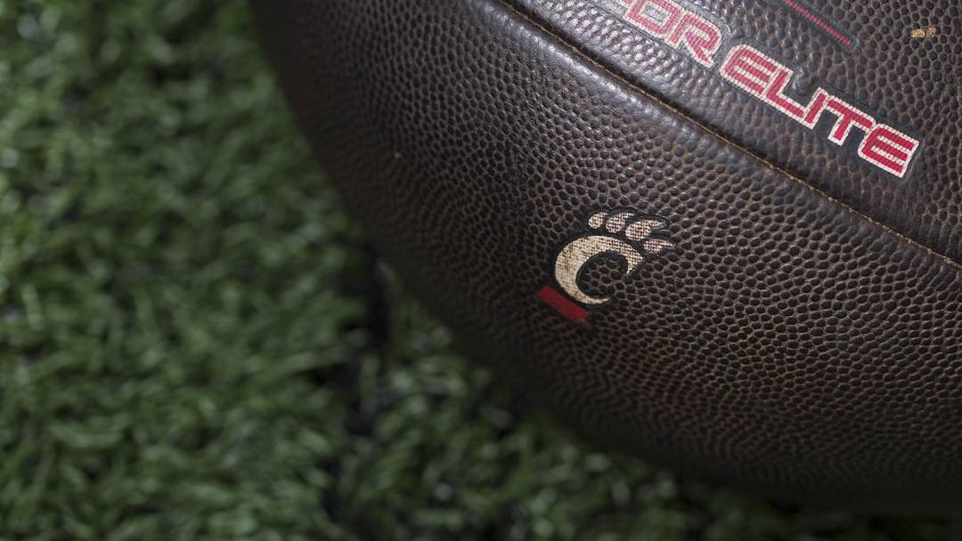 Sep 6, 2025; Cincinnati, Ohio, USA; The Cincinnati logo is seen on a football before the game between the Bowling Green Falcons and the Cincinnati Bearcats at Nippert Stadium. Mandatory Credit: Aaron Doster-Imagn Images