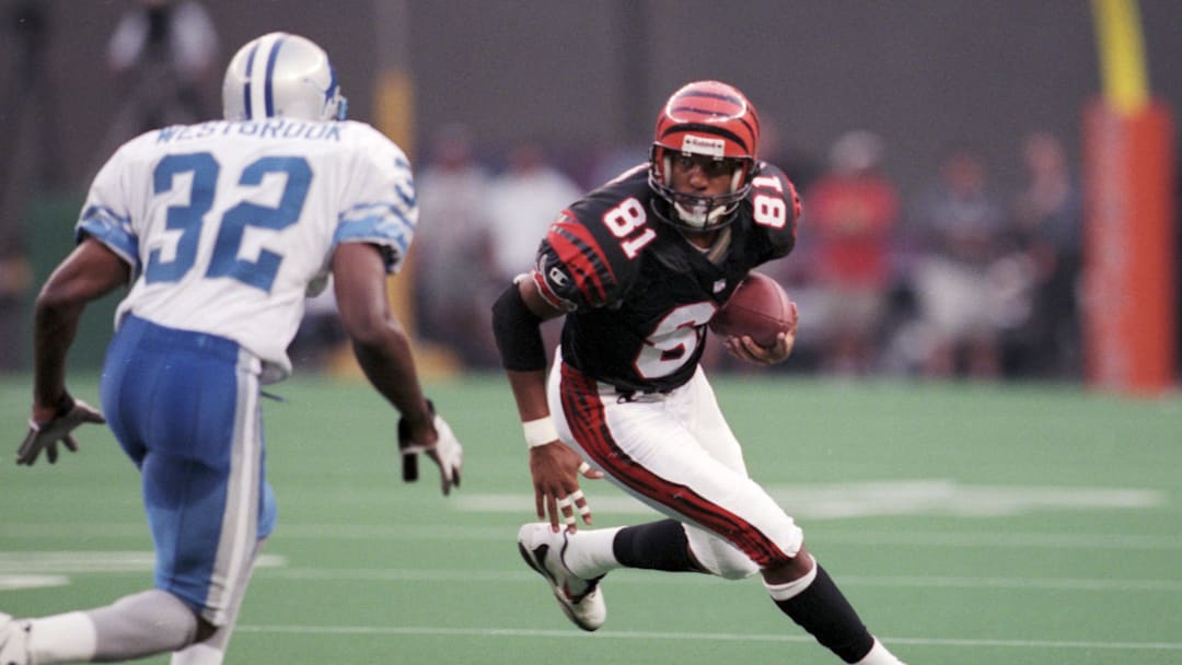 Sep 13, 1998; Cincinnati, OH, USA; FILE PHOTO; Cincinnati Bengals receiver Carl Pickens (81) runs after a catch against the Detroit Lions cornerback Bryant Westbrook (32) at Riverfront Stadium. The Bengals defeated the Lions 34-28. Mandatory Credit: Matthew Emmons-Imagn Images