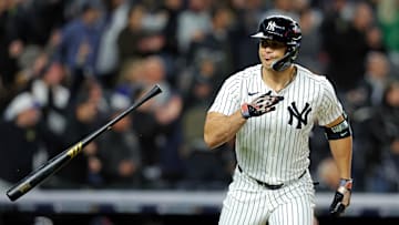 Oct 14, 2024; Bronx, New York, USA; New York Yankees designated hitter Giancarlo Stanton (27) hits a solo home run during the seventh inning against the Cleveland Guardians in game one of the ALCS for the 2024 MLB Playoffs at Yankee Stadium. Mandatory Credit: Brad Penner-Imagn Images
