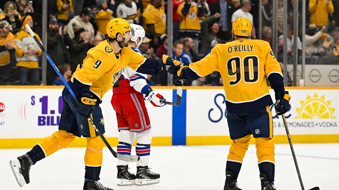 Dec 21, 2025; Nashville, Tennessee, USA;  Nashville Predators left wing Filip Forsberg (9) and center Ryan O'Reilly (90) celebrate the win during the third period at Bridgestone Arena. Mandatory Credit: Steve Roberts-Imagn Images