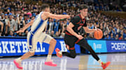Feb 15, 2025; Durham, North Carolina, USA;  Stanford Cardinal forward Maxime Raynaud (42) brings the ball around Duke Blue Devils forward Mason Gillis (18) during the first half at Cameron Indoor Stadium. Mandatory Credit: Zachary Taft-Imagn Images