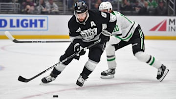 Feb 7, 2025; Los Angeles, California, USA; Los Angeles Kings defenseman Drew Doughty (8) moves the puck against Dallas Stars center Oskar Back (10) durng the first period at Crypto.com Arena. Mandatory Credit: Gary A. Vasquez-Imagn Images