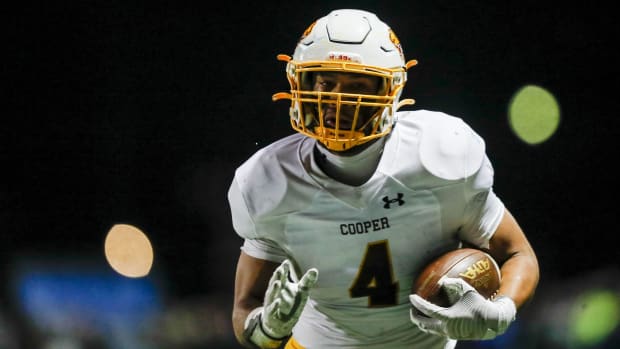 Cooper tight end Austin Alexander runs with the ball for a touchdown against Highlands on Nov. 24, 2023.