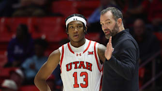 Utah Runnin' Utes head coach Alex Jensen speaks with forward Kendyl Sanders (13) during the second half of a game at Jon M. Huntsman Center.