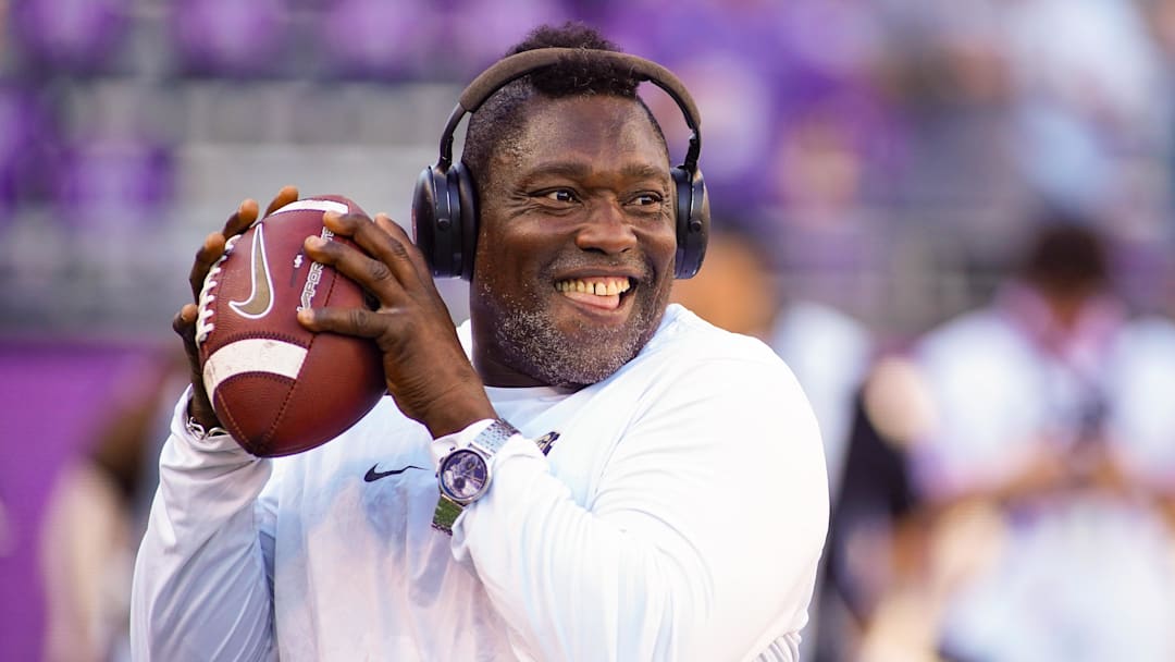 Oct 4, 2025; Fort Worth, Texas, USA; Colorado Buffaloes defensive pass rush coordinator Warren Sapp plays catch on the sidelines prior to a game between the TCU Horned Frogs and the Colorado Buffaloes at Amon G. Carter Stadium. Mandatory Credit: Raymond Carlin III-Imagn Images
