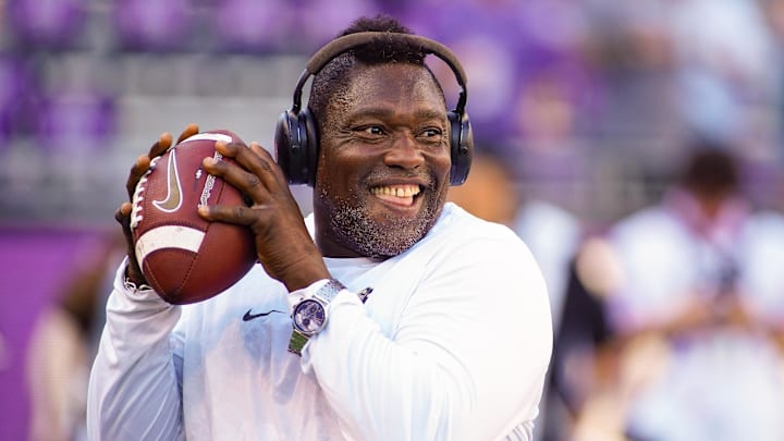 Oct 4, 2025; Fort Worth, Texas, USA; Colorado Buffaloes defensive pass rush coordinator Warren Sapp plays catch on the sidelines prior to a game between the TCU Horned Frogs and the Colorado Buffaloes at Amon G. Carter Stadium. Mandatory Credit: Raymond Carlin III-Imagn Images