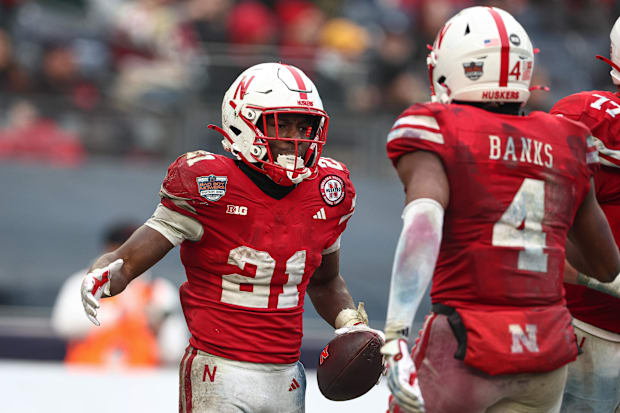 Nebraska Cornhuskers running back Emmett Johnson (21) celebrates with teammates after a touchdown.