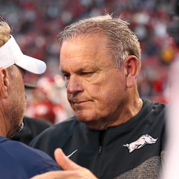 Former Liberty Flames coach Hugh Freeze, left, talks to Arkansas Razorbacks coach Sam Pittman after the game at Donald W. Reynolds Razorback Stadium. Liberty won 21-19.
