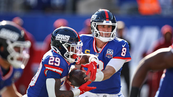 Daniel Jones hands it off against the Washington Commanders Daniel Jones hands it off against the Washington Commanders