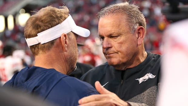 Auburn coach Hugh Freeze speaks with Arkansas coach Sam Pittman in 2022.
