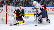 Jan 25, 2025; Vancouver, British Columbia, CAN; Washington Capitals forward Aliaksei Protas (21) and Vancouver Canucks defenseman Quinn Hughes (43) watch goalie Kevin Lankinen (32) make a save in the third period at Rogers Arena. Mandatory Credit: Bob Frid-Imagn Images