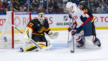 Jan 25, 2025; Vancouver, British Columbia, CAN; Washington Capitals forward Aliaksei Protas (21) and Vancouver Canucks defenseman Quinn Hughes (43) watch goalie Kevin Lankinen (32) make a save in the third period at Rogers Arena. Mandatory Credit: Bob Frid-Imagn Images