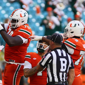 Sep 7, 2024; Miami Gardens, Florida, USA; Miami Hurricanes tight end Elijah Arroyo (8) celebrates with Miami Hurricanes offensive lineman Markel Bell (70) after scoring a touchdown against Florida A&M Rattlers during the first quarter at Hard Rock Stadium. Mandatory Credit: Sam Navarro-Imagn Images