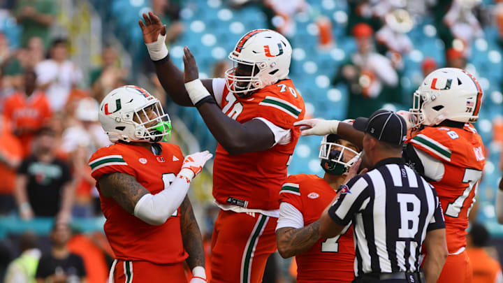 Sep 7, 2024; Miami Gardens, Florida, USA; Miami Hurricanes tight end Elijah Arroyo (8) celebrates with Miami Hurricanes offensive lineman Markel Bell (70) after scoring a touchdown against Florida A&M Rattlers during the first quarter at Hard Rock Stadium. Mandatory Credit: Sam Navarro-Imagn Images