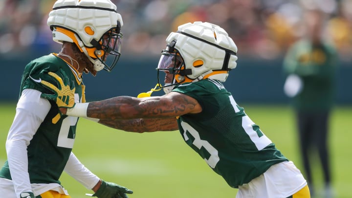 Green Bay Packers cornerbacks Eric Stokes (21) and Jaire Alexander (23) run through a drill at training camp.