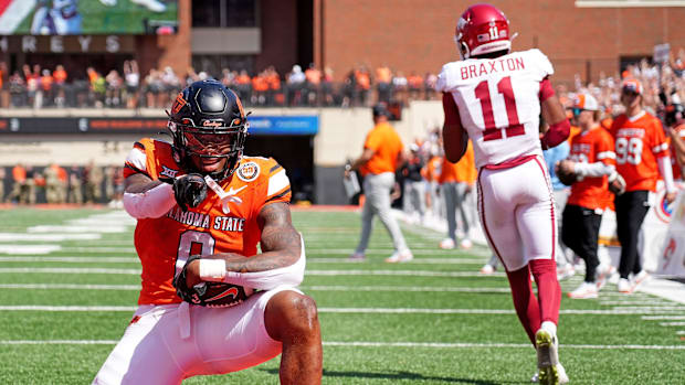 Oklahoma State's Ollie Gordon II (0) celebrates a 2-point conversion in double overtime.