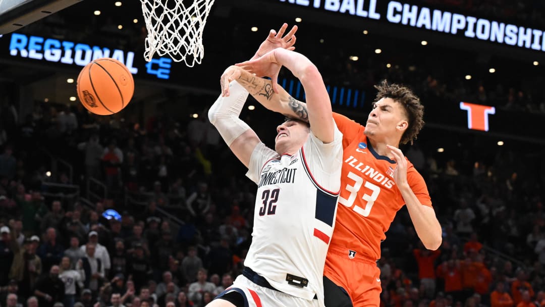 Mar 30, 2024; Boston, MA, USA; Connecticut Huskies guard Cam Spencer (12) shoots the ball on Illinois Fighting Illini forward Coleman Hawkins (33) in the finals of the East Regional of the 2024 NCAA Tournament at TD Garden. Mandatory Credit: Brian Fluharty-USA TODAY Sports