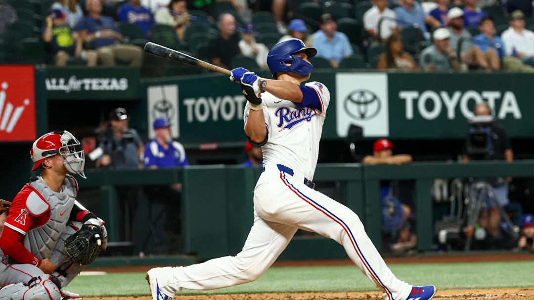 Aug 27, 2025; Arlington, Texas, USA;  Texas Rangers shortstop Corey Seager (5) hits a two-run home run during the fourth inning against the Los Angeles Angels at Globe Life Field. 