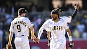 Mar 27, 2025; San Diego, California, USA; San Diego Padres first baseman Jake Cronenworth (9) and Fernando Tatis Jr. (23) celebrate after the Padres defeated the Atlanta Braves 7-4 at Petco Park. 