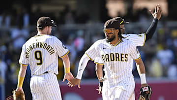 Mar 27, 2025; San Diego, California, USA; San Diego Padres first baseman Jake Cronenworth (9) and Fernando Tatis Jr. (23) celebrate after the Padres defeated the Atlanta Braves 7-4 at Petco Park. 