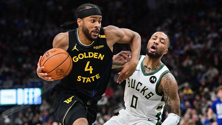 Feb 10, 2025; Milwaukee, Wisconsin, USA;  Golden State Warriors forward Moses Moody (4) drives for the basket against Milwaukee Bucks guard Damian Lillard (0) in the second quarter at Fiserv Forum. Mandatory Credit: Benny Sieu-Imagn Images