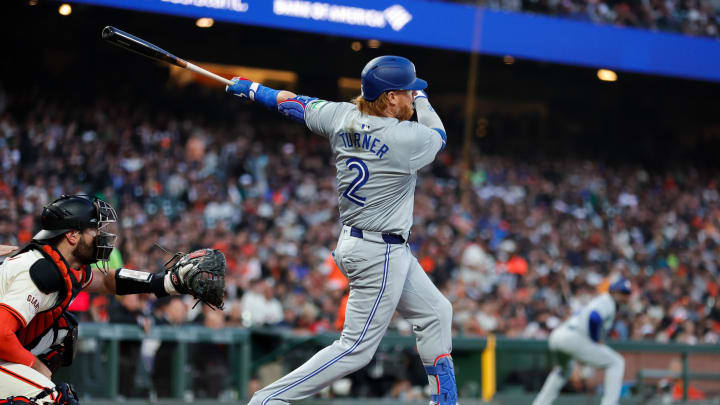 Jul 10, 2024; San Francisco, California, USA; Toronto Blue Jays first base Justin Turner (2) hits a RBI single during the sixth inning against the San Francisco Giants at Oracle Park. Mandatory Credit: Sergio Estrada-USA TODAY Sports