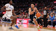Nov 14, 2025; Inglewood, California, USA;  Arizona Wildcats guard Brayden Burries (5) drives to the basket against UCLA Bruins center Xavier Booker (1) during the first half of the Hall of Fame Series game at Intuit Dome. Mandatory Credit: Kiyoshi Mio-Imagn Images