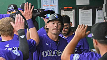 Apr 24, 2025; Kansas City, Missouri, USA;  Colorado Rockies left fielder Jordan Beck (27) celebrates in the dugout after hitting a solo homerun in the eighth inning against the Kansas City Royals at Kauffman Stadium. Mandatory Credit: Peter Aiken-Imagn Images