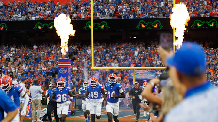 Aug 30, 2025; Gainesville, Florida, USA; Florida Gators defensive back Vincent Brown Jr. (36), Florida Gators edge Jalen Wiggins (49) and Florida Gators defensive back Jordan Castell (14) run onto the field before a game against the Long Island Sharks at Ben Hill Griffin Stadium. Mandatory Credit: Matt Pendleton-Imagn Images