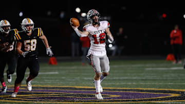 Iowa City High quarterback Drew Larson (12) throws the ball during the first round of 5A playoffs at Dragon Stadium on Friday, Oct. 28, 2022. The Dragons defeated the Little Hawks in overtime, 38-31.