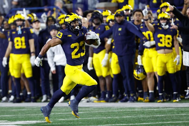 Michigan Wolverines running back Jordan Marshall (23) runs the ball on a kickoff return.