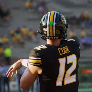 Missouri Tigers quarterback Brady Cook follows through on a pass during warm ups at Faurot Field ahead of a game against Murray State In Columbia, Mo. on Tuesday, August 13, 2024.