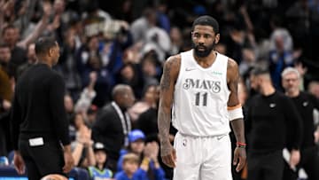 Dallas Mavericks guard Kyrie Irving looks on after he makes a three-point shot.