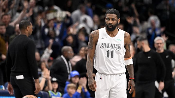 Dallas Mavericks guard Kyrie Irving looks on after he makes a three-point shot. Dallas Mavericks guard Kyrie Irving looks on after he makes a three-point shot.