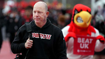 Louisville’s Jeff Brohm walks during the Card March before the game before Kentucky in the Governor’s Cup