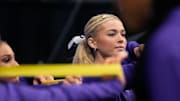 LSU gymnast Livvy Dunne stretches with teammates before Session 2 of the SEC Gymnastics Tournament.