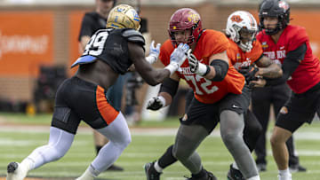 National team defensive lineman Oluwafemi Oladejo of UCLA (99) and National team offensive lineman Jalen Travis of Iowa State (72) work through drills during Senior Bowl practice at Hancock Whitney Stadium.