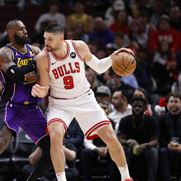  Los Angeles Lakers forward LeBron James (23) defends against Chicago Bulls center Nikola Vucevic (9) during the second half at United Center. Mandatory Credit: Kamil Krzaczynski-Imagn Images