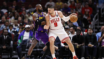 Dec 20, 2023; Chicago, Illinois, USA; Los Angeles Lakers forward LeBron James (23) defends against Chicago Bulls center Nikola Vucevic (9) during the second half at United Center. Mandatory Credit: Kamil Krzaczynski-Imagn Images