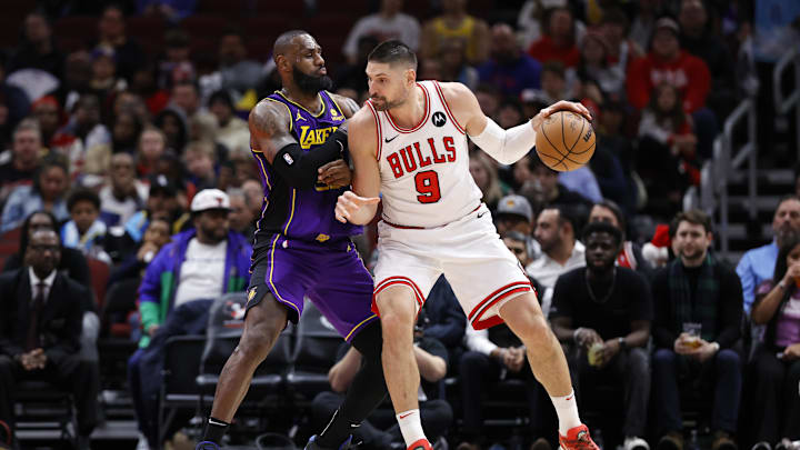 Dec 20, 2023; Chicago, Illinois, USA; Los Angeles Lakers forward LeBron James (23) defends against Chicago Bulls center Nikola Vucevic (9) during the second half at United Center. Mandatory Credit: Kamil Krzaczynski-Imagn Images