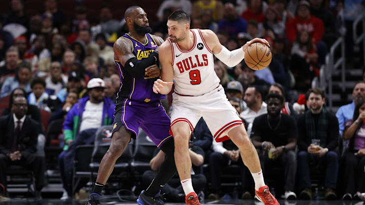 Dec 20, 2023; Chicago, Illinois, USA; Los Angeles Lakers forward LeBron James (23) defends against Chicago Bulls center Nikola Vucevic (9) during the second half at United Center. Mandatory Credit: Kamil Krzaczynski-Imagn Images