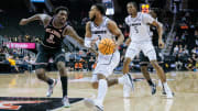 Mar 12, 2024; Kansas City, MO, USA; UCF Knights guard Darius Johnson (3) drives to the basket around Oklahoma State Cowboys forward Eric Dailey Jr. (2) during the first half at T-Mobile Center. Mandatory Credit: William Purnell-USA TODAY Sports