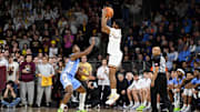Jan 20, 2024; Chestnut Hill, Massachusetts, USA; Boston College Eagles guard Donald Hand Jr. (13) shoots the ball over North Carolina Tar Heels forward Harrison Ingram (55) during the first half at Conte Forum. Mandatory Credit: Eric Canha-Imagn Images